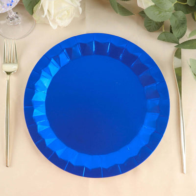Blue paper plate on a table setting with silver fork and greenery.