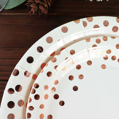 Rose gold polka dot paper plates on a wooden surface.