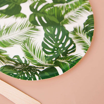 Tropical leaf print serving tray on a soft pink background.