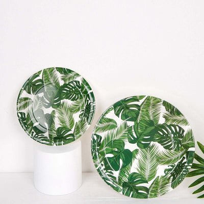Green tropical leaf plates on a white pedestal.