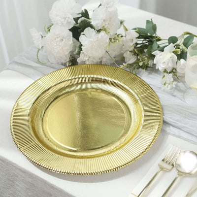 Gold charger plate on a beautifully set table with flowers.