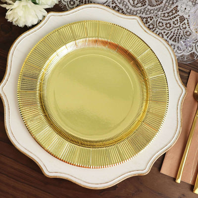 Elegant gold charger plate with a decorative edge on a rustic wooden table.