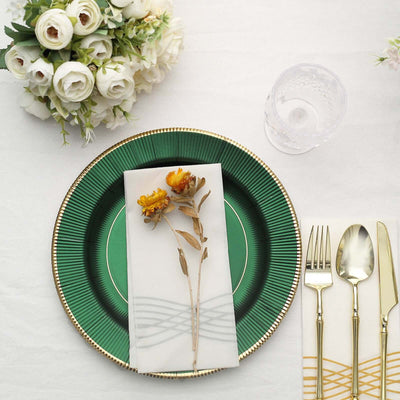 Elegant green plate with floral napkin, cutlery, and bouquet.