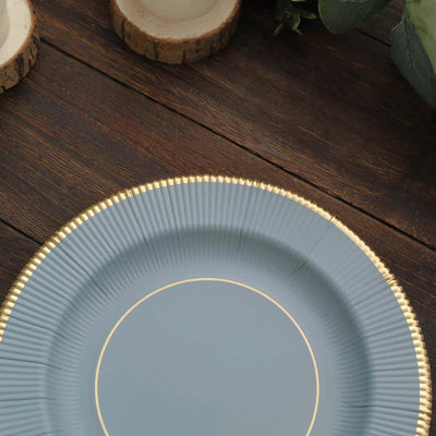 Elegant blue plate with gold rim on rustic wooden table.