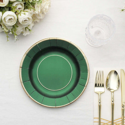 Green decorative plate with gold rim on a table setting.