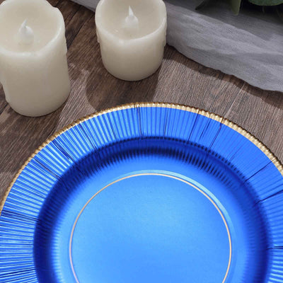 Blue decorative plate with gold trim on a wooden surface.