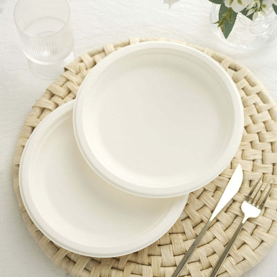 White disposable plates on a woven placemat with cutlery.