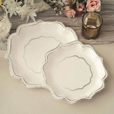 Elegant white serving plates with silver trim, perfect for any occasion.