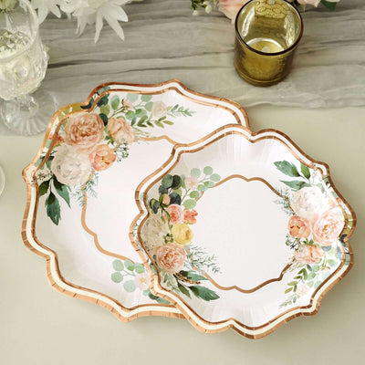 Floral decorative plates with gold trim on a neutral background.