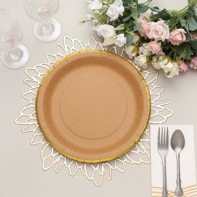 Brown paper plate with gold rim on decorative placemat surrounded by tableware and flowers.