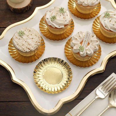 Assorted decorative cupcakes on a golden platter.