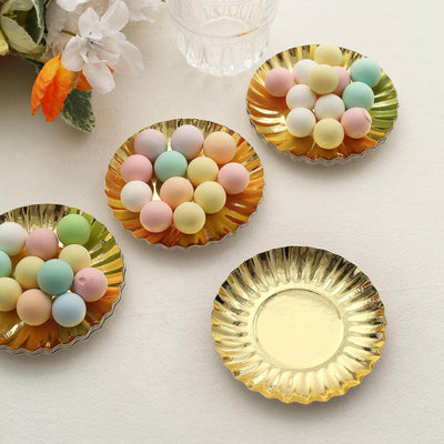 Colorful pastel candy-coated chocolates on gold plates.