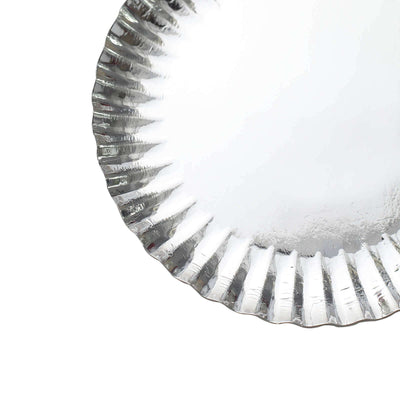 Silver foil pie plate with fluted edges on a white background.