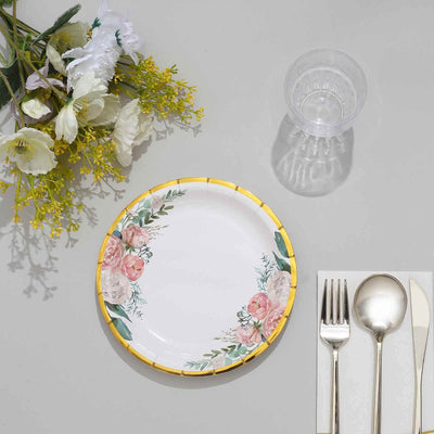 Floral paper plate with yellow trim on a table setting with utensils and glass.