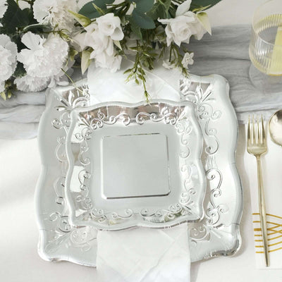 Elegant silver decorative plate on a beautifully set table with flowers.