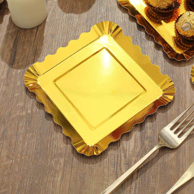 Gold scalloped dessert plate on a wooden surface.