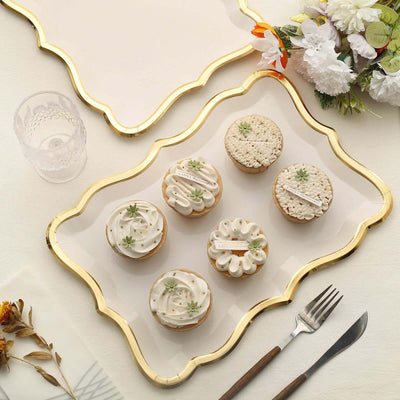 Assorted decorative cupcakes on an elegant platter with floral accents.