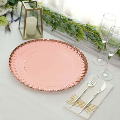 Elegant pink charger plate with scalloped edge on a dining table setting.