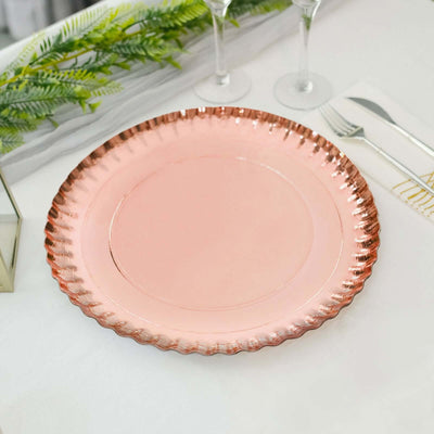 Rose gold charger plate with scalloped edges on a table setting.