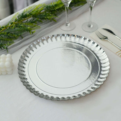 Elegant silver serving platter with scalloped edge on a table setting.