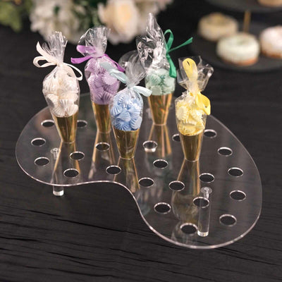 Clear acrylic dessert display stand with colorful cupcake cones.