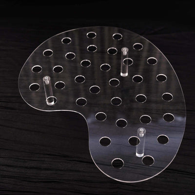 Acrylic paint palette with multiple holes for mixing colors.