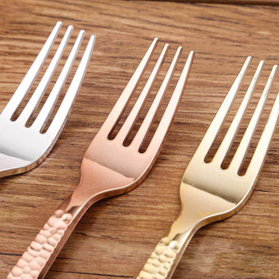 Set of three decorative forks in silver, rose gold, and gold finishes.