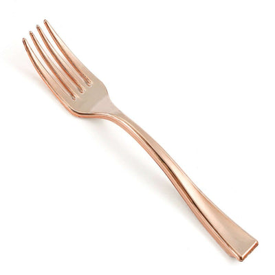 Rose gold fork on a plain background.