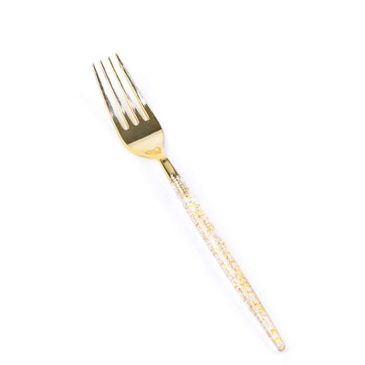 Gold fork with a clear, embellished handle on a white background