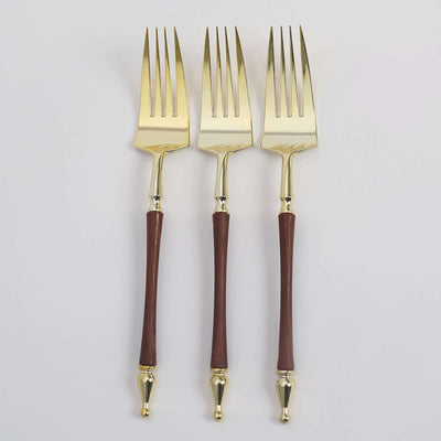 Set of three elegant gold and wood-handled forks