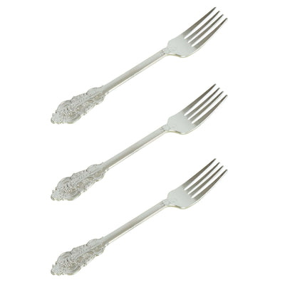 Set of three ornate silver forks on a white background.