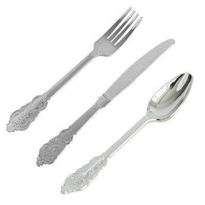 Silver cutlery set including fork, knife, and spoon on white background
