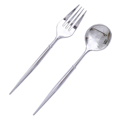 Silver serving fork and spoon set on a plain background.