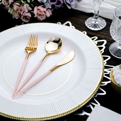 Gold-accented cutlery set with pink handles on an elegant plate