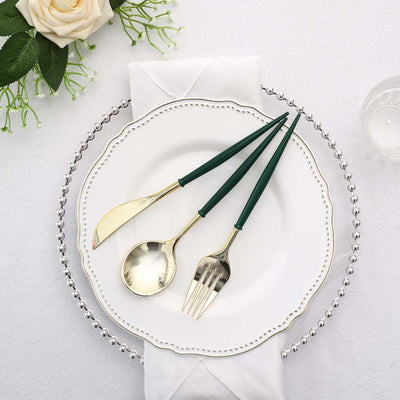 Elegant green-handled cutlery set on a decorative plate with a napkin.