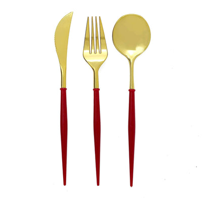 Gold cutlery set with red handles: knife, fork, and spoon