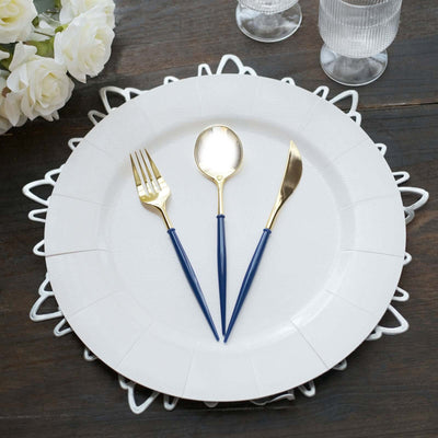 Elegant gold and blue cutlery set on a white plate with decorative edges.