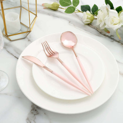 Rose gold cutlery set on a white plate with floral accents.