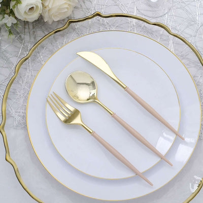 Elegant gold cutlery set on decorative plates for dining.