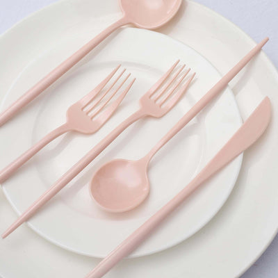 Pastel pink cutlery set on white plates