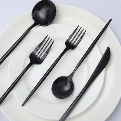 Black disposable cutlery set on white plates.