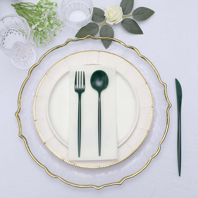 Elegant table setting with green cutlery on a decorative plate.