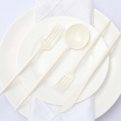 White disposable tableware set including forks, spoon, knife, and plates