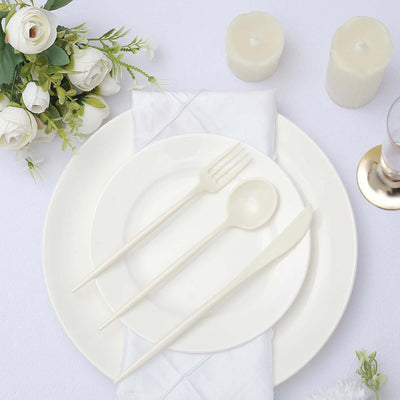 Elegant white dinnerware set with utensils and floral accents.