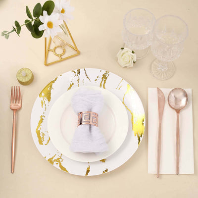 Elegant dining set with gold accents, napkin holder, and crystal glasses.