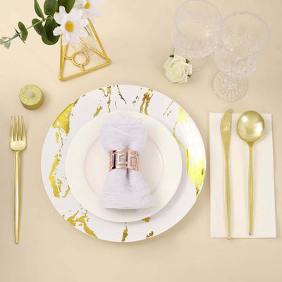 Elegant table setting with gold accents and decorative napkin holder.