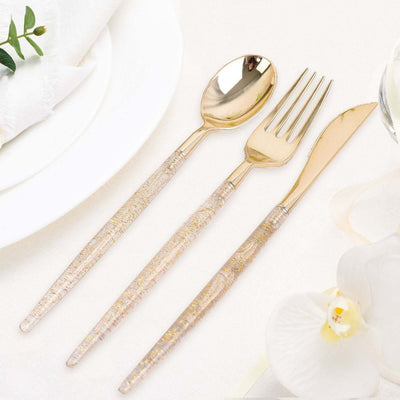 Elegant gold cutlery set with textured handles on a table setting.