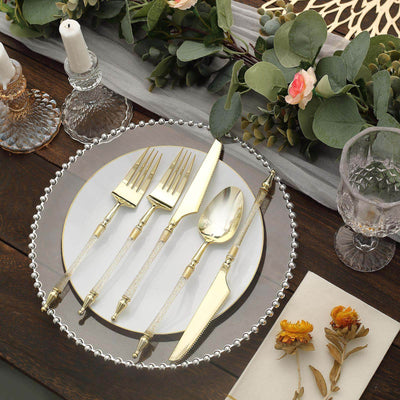 Elegant gold cutlery set on a decorative plate with floral accents.