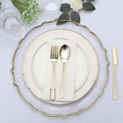 Elegant dining set with gold-accented plates and utensils.