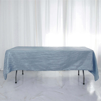 Blue textured tablecloth on a folding table with soft natural light.